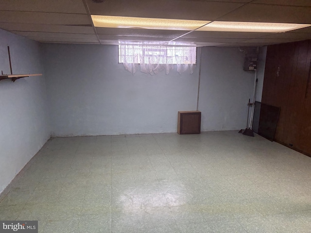 basement featuring a paneled ceiling