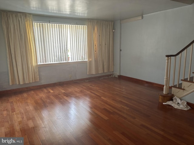 unfurnished room with hardwood / wood-style floors