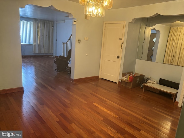 interior space featuring dark hardwood / wood-style flooring and a notable chandelier