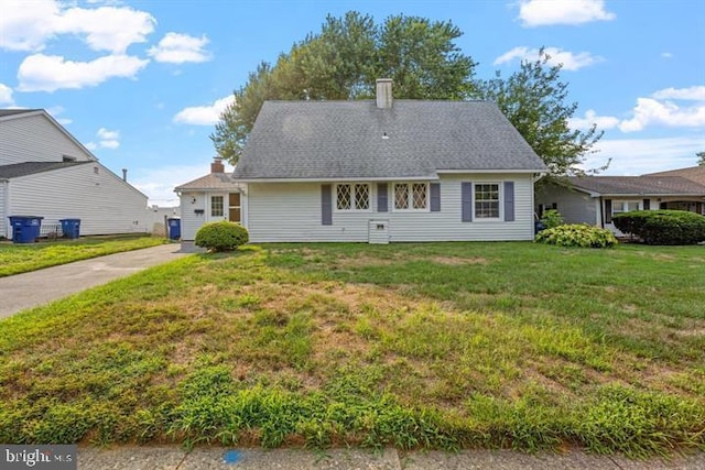 rear view of property with a yard