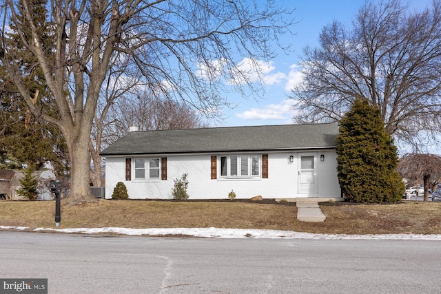 ranch-style home with central AC and a front lawn