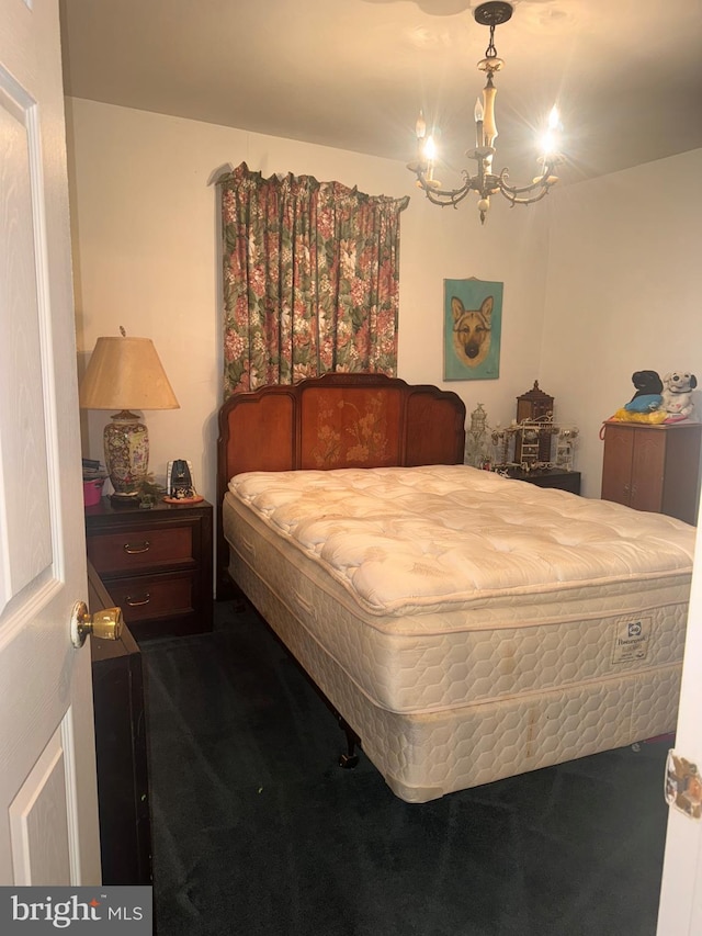 bedroom featuring carpet and a notable chandelier