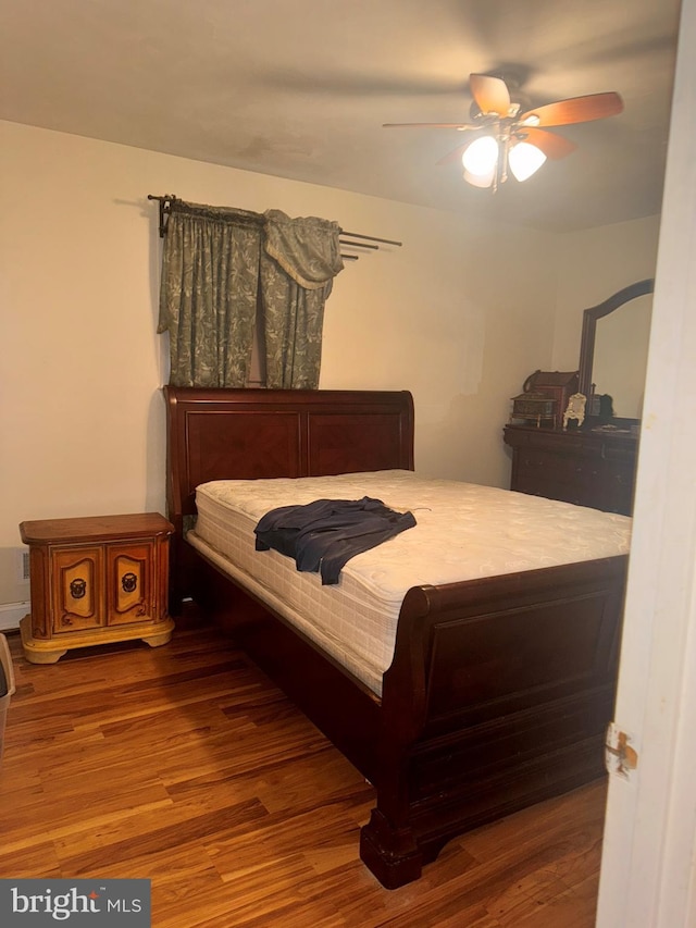 bedroom featuring hardwood / wood-style flooring and ceiling fan