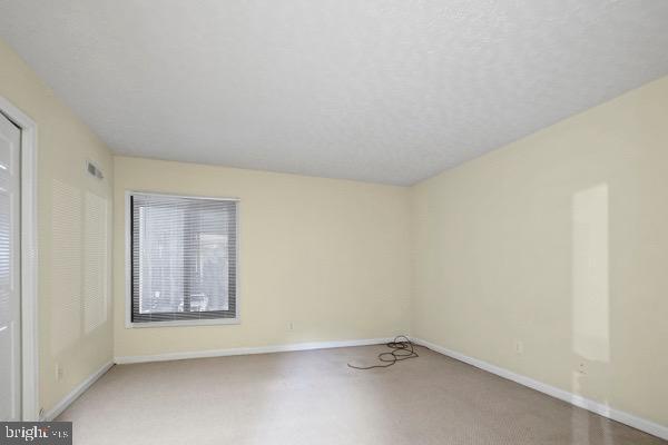 spare room featuring a textured ceiling