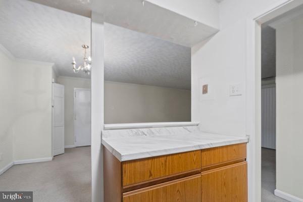 bathroom featuring crown molding and a textured ceiling