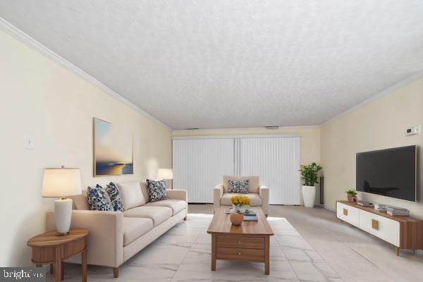 living room with crown molding and a textured ceiling