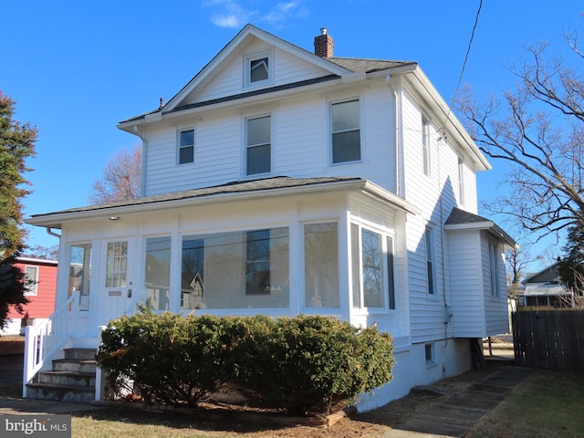 view of front of house featuring a sunroom