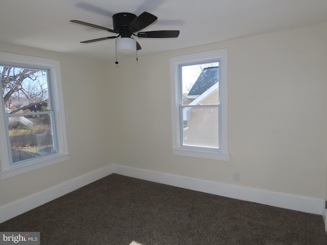 unfurnished room with ceiling fan, carpet flooring, and a wealth of natural light