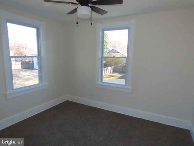 carpeted empty room featuring a healthy amount of sunlight and ceiling fan