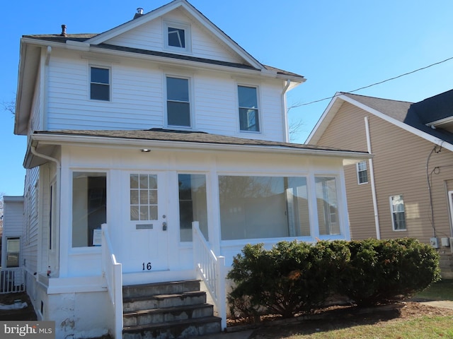 view of front of house featuring a sunroom