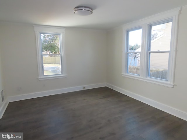 empty room featuring dark wood-type flooring