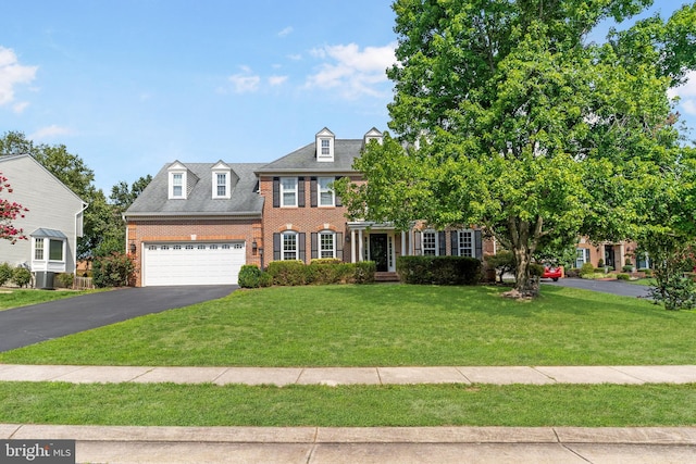 view of front of house with central AC and a front lawn