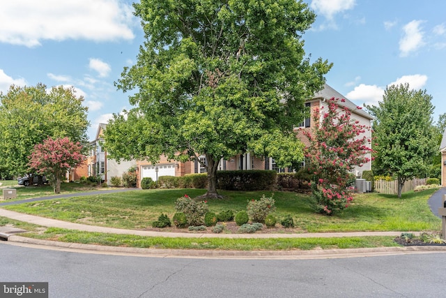 obstructed view of property featuring cooling unit, a garage, and a front lawn