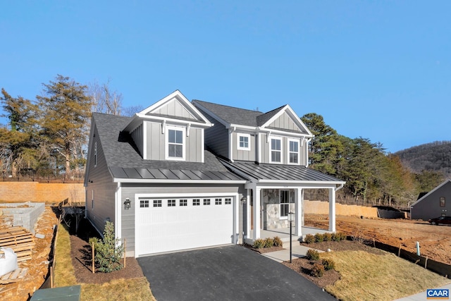 view of front of home featuring a porch, a garage, and a front lawn