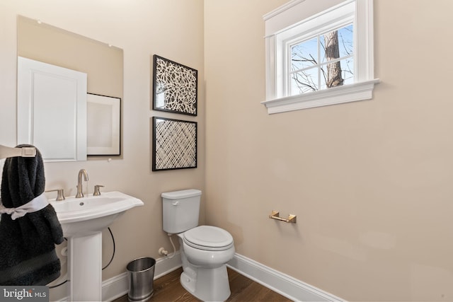 bathroom with wood-type flooring, sink, and toilet