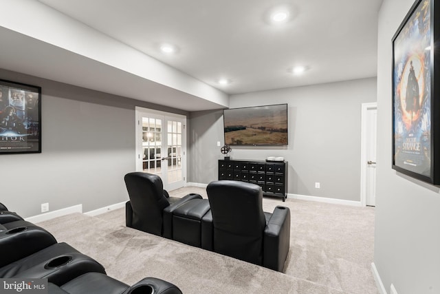 carpeted home theater room featuring french doors