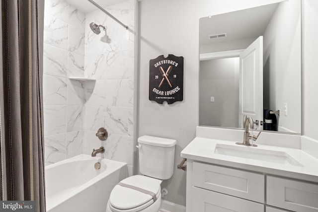 full bathroom with tiled shower / bath combo, vanity, and toilet