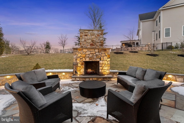 patio terrace at dusk featuring an outdoor living space with a fireplace