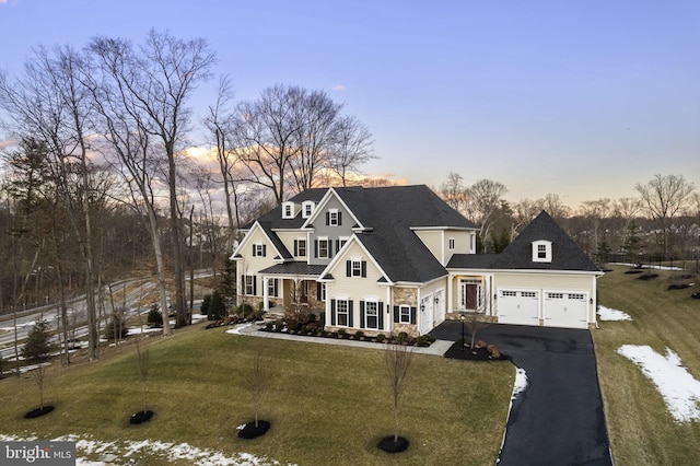 view of front facade with a garage and a lawn