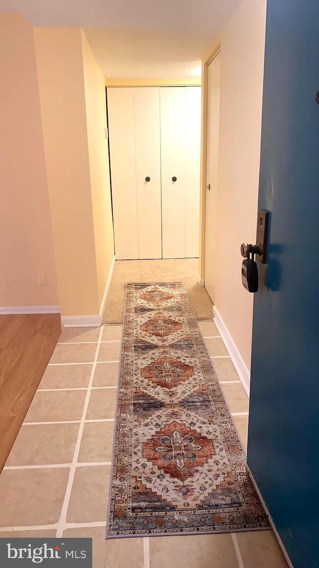 hallway with light tile patterned floors