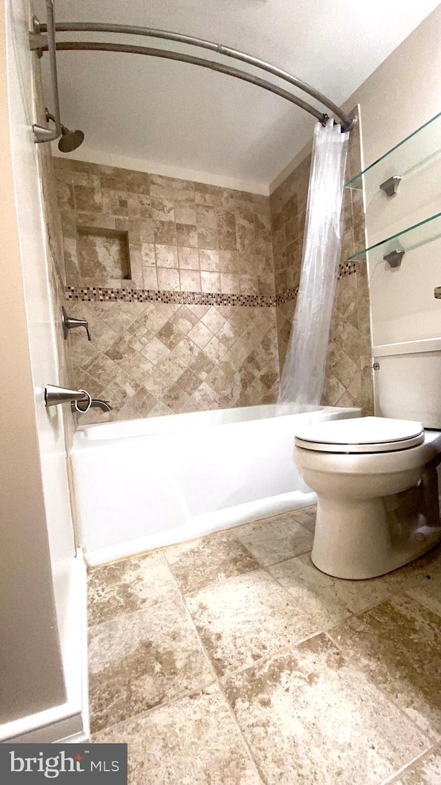 bathroom featuring shower / bathtub combination with curtain and toilet