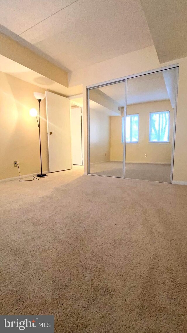 basement featuring carpet and a textured ceiling