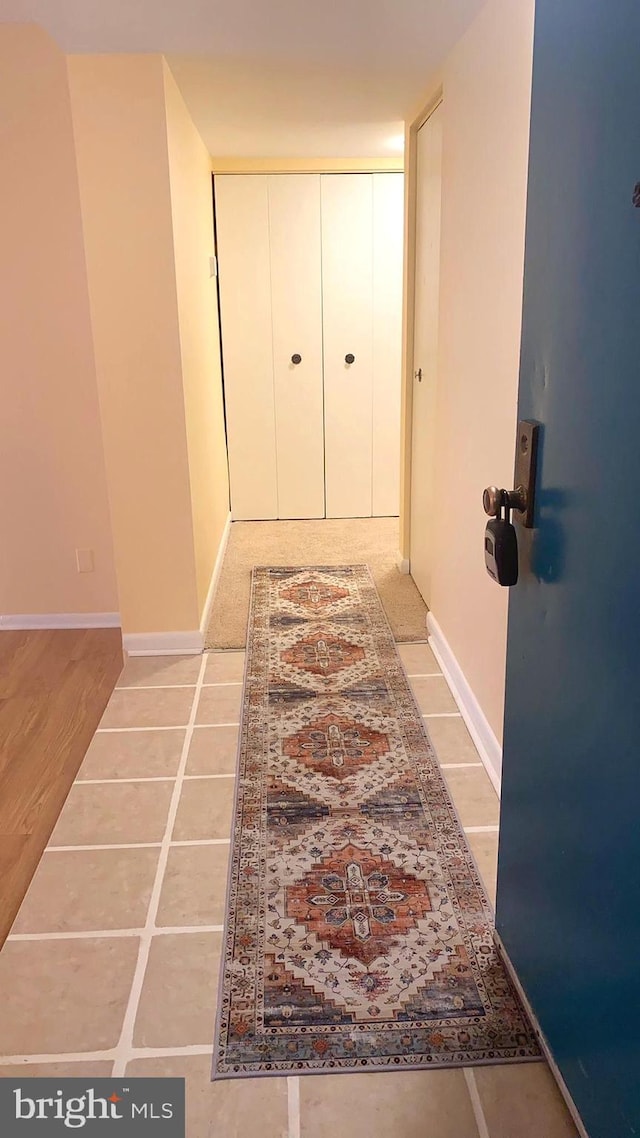 hall with light tile patterned flooring