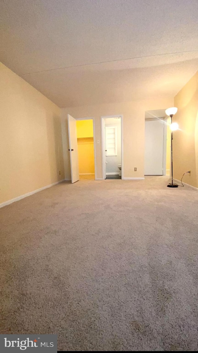 spare room with carpet floors and a textured ceiling