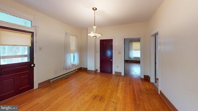 foyer with a baseboard radiator and light hardwood / wood-style floors