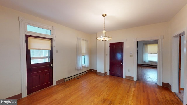 entryway with light wood-type flooring and baseboard heating