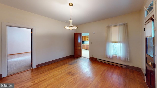 spare room with light hardwood / wood-style flooring and a baseboard heating unit