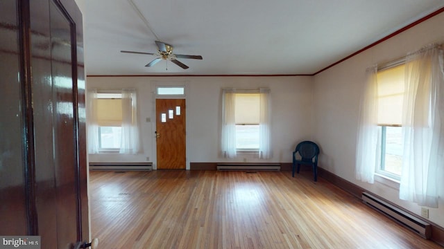 interior space featuring crown molding, a baseboard radiator, and light hardwood / wood-style flooring