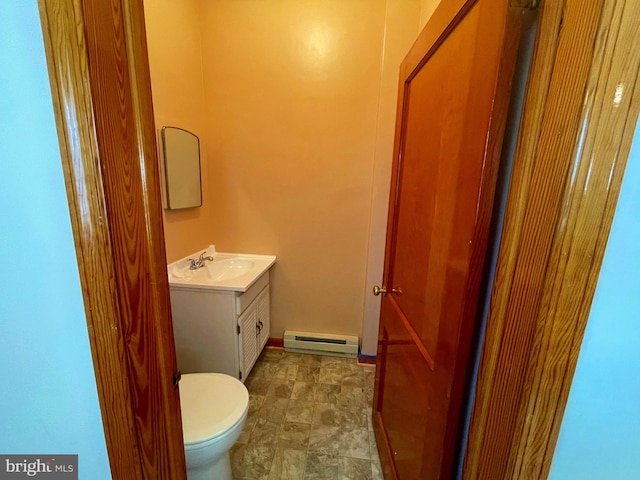 bathroom featuring vanity, baseboard heating, and toilet