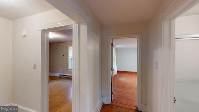 hallway with hardwood / wood-style flooring and a baseboard radiator