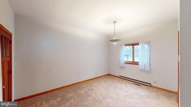 carpeted empty room featuring a baseboard radiator