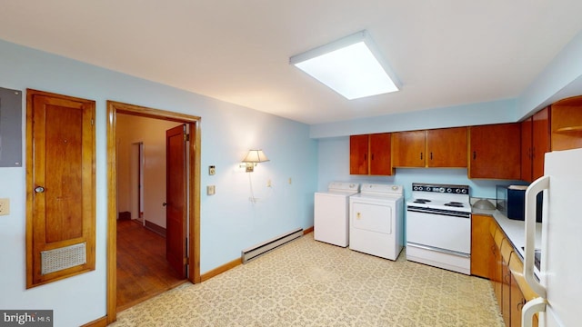 clothes washing area featuring a baseboard heating unit and washing machine and dryer