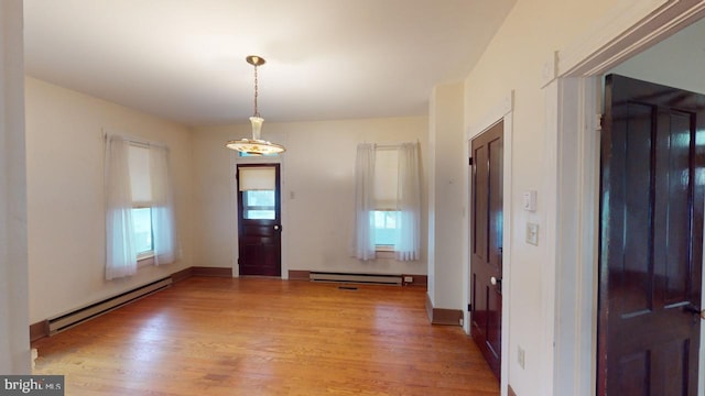 foyer featuring baseboard heating and light hardwood / wood-style flooring