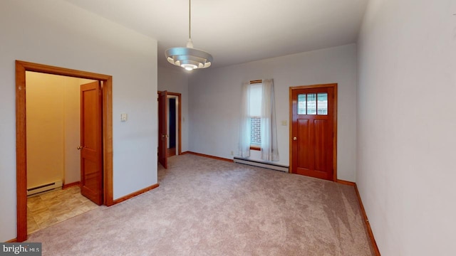 foyer featuring light carpet and a baseboard heating unit