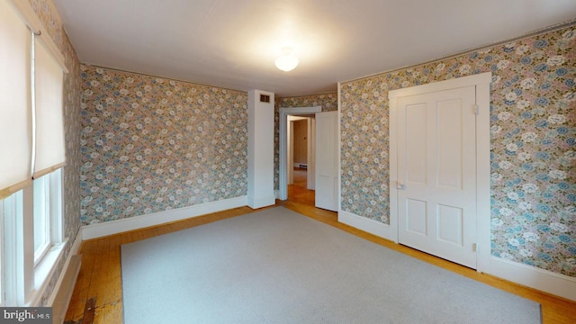 unfurnished bedroom with wood-type flooring