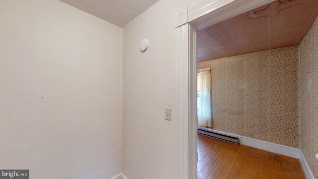 hall featuring baseboard heating and hardwood / wood-style floors