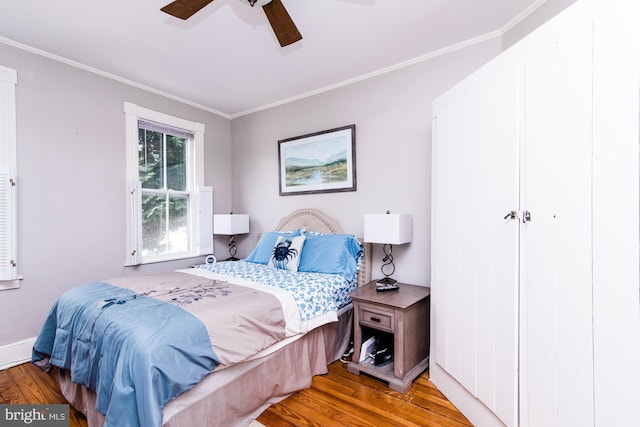 bedroom with ceiling fan, ornamental molding, and hardwood / wood-style floors