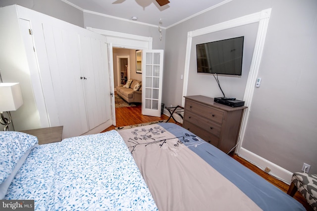 bedroom featuring light hardwood / wood-style floors, ornamental molding, french doors, and ceiling fan