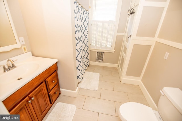 bathroom with tile patterned flooring, vanity, and toilet