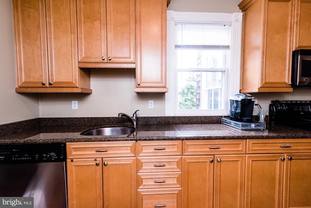 kitchen featuring appliances with stainless steel finishes, sink, and dark stone countertops