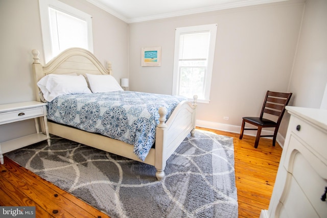 bedroom with hardwood / wood-style floors and ornamental molding