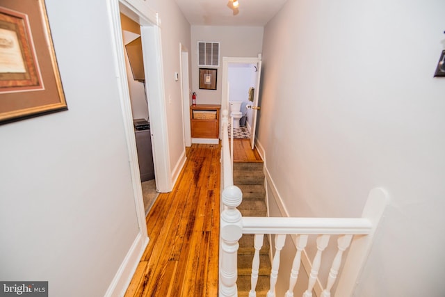 hallway with hardwood / wood-style flooring