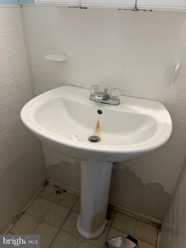 bathroom with tile walls and tile patterned flooring