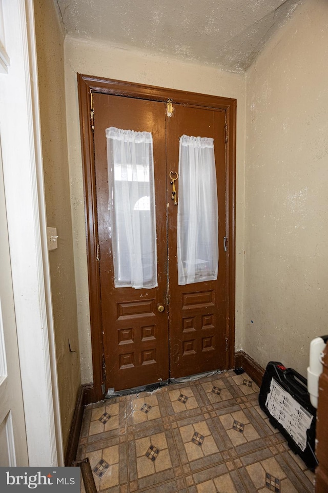 doorway featuring french doors and a textured ceiling