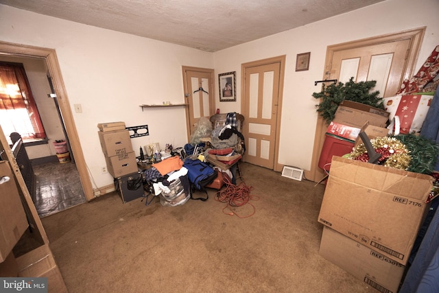 interior space with dark colored carpet and a textured ceiling