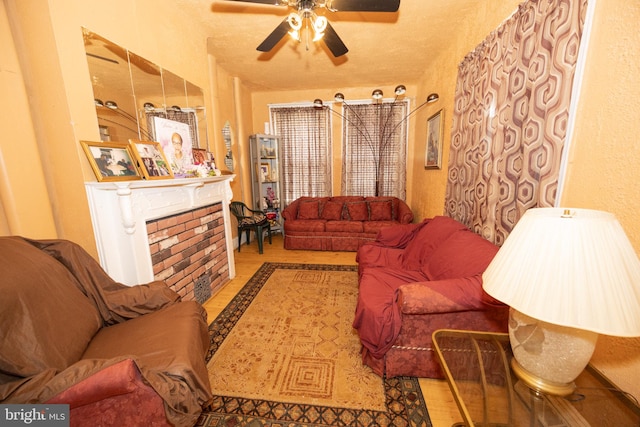 living room featuring ceiling fan and a fireplace